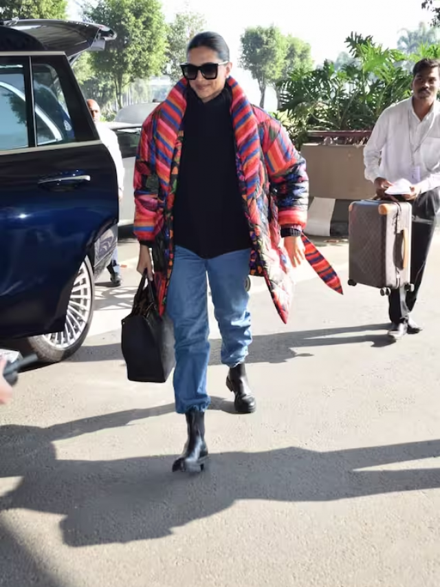 लॉन्ग कोट के साथ डेनिम और ब्लैक स्वेटर में Deepika Padukone का स्वैग