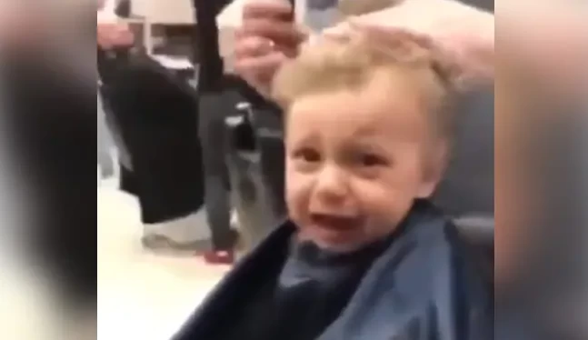 The child was crying while getting his hair cut so the salon guy sang a  funny