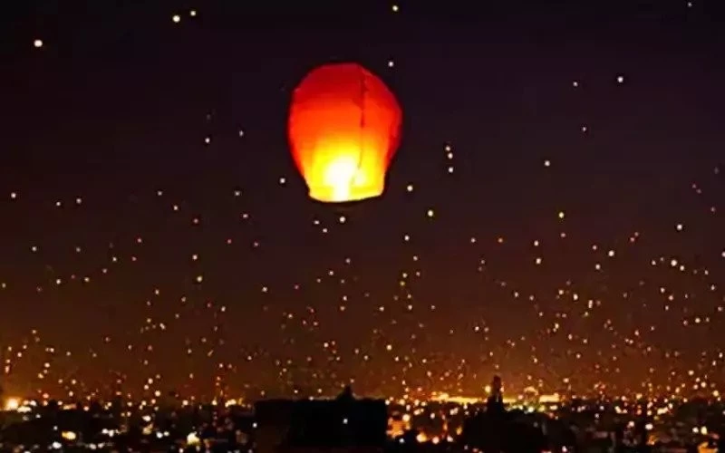 Kite flying in the city by day, fireworks by night; Wishing lamps shine like stars