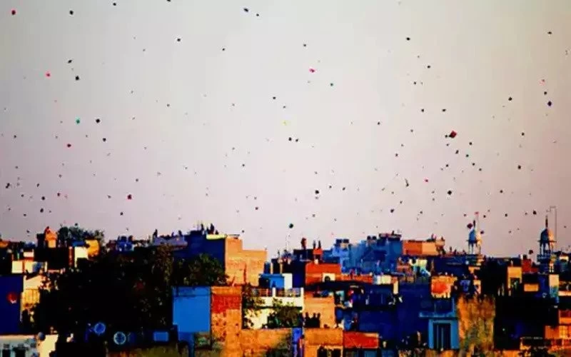 Kite flying in the city by day, fireworks by night; Wishing lamps shine like stars