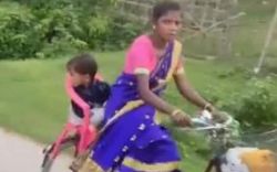 Mother adjusts chair over bicycle for little child social media applause